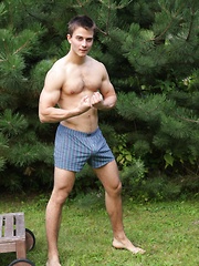 In a luscious outdoor setting, two hunky athletic uncut studs are busy getting down and dirty amongst the wild life