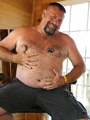 Grizzly Daddy Jake Davidson strips off his T-Shirt and shows off his hairy belly and hard cock