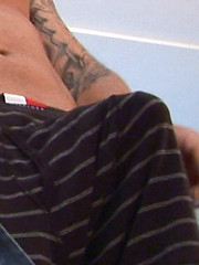 Tony D is looking at some porn on his handheld as his cock starts to come to life